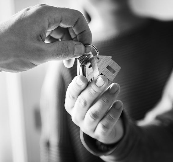 Deux personnes qui s'échangent un jeux de clé après un achat immobilier